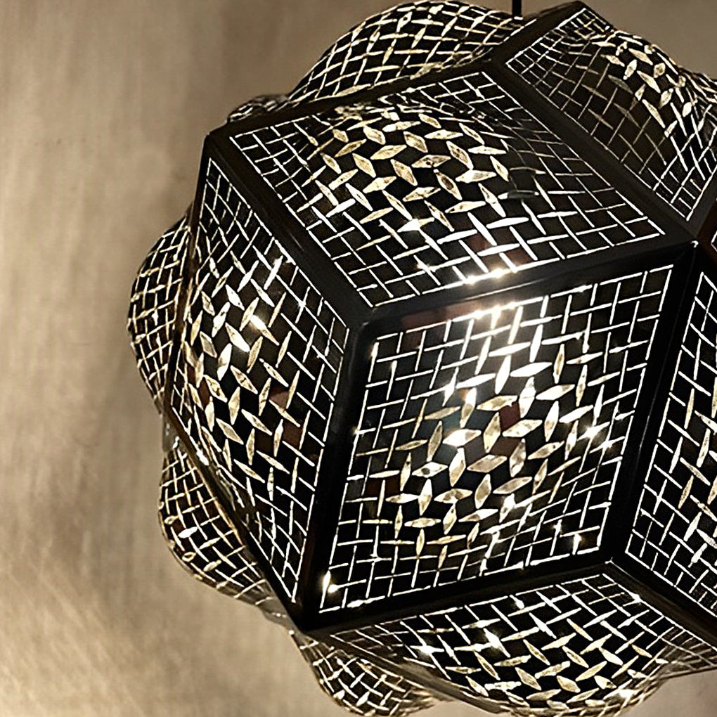 Polyhedron pendant light with a white finish, providing soft illumination in a living room.