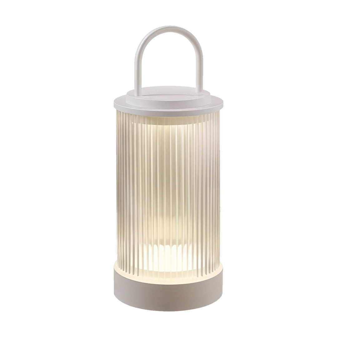 Portable lantern in outdoor dining scene placed on table providing relaxing evening illumination.