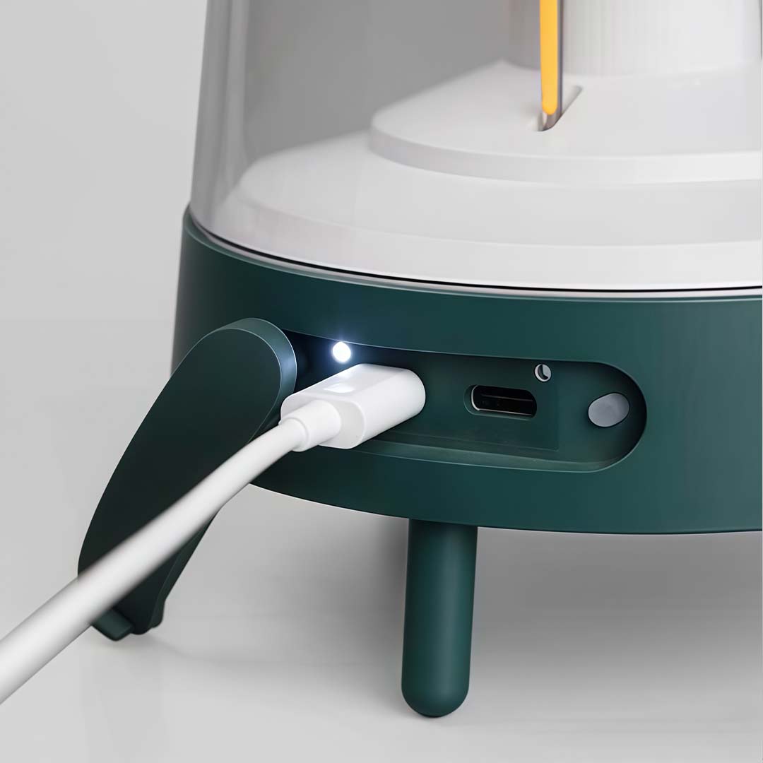 Portable rechargeable LED lamp with a black finish, providing illumination in a tent.