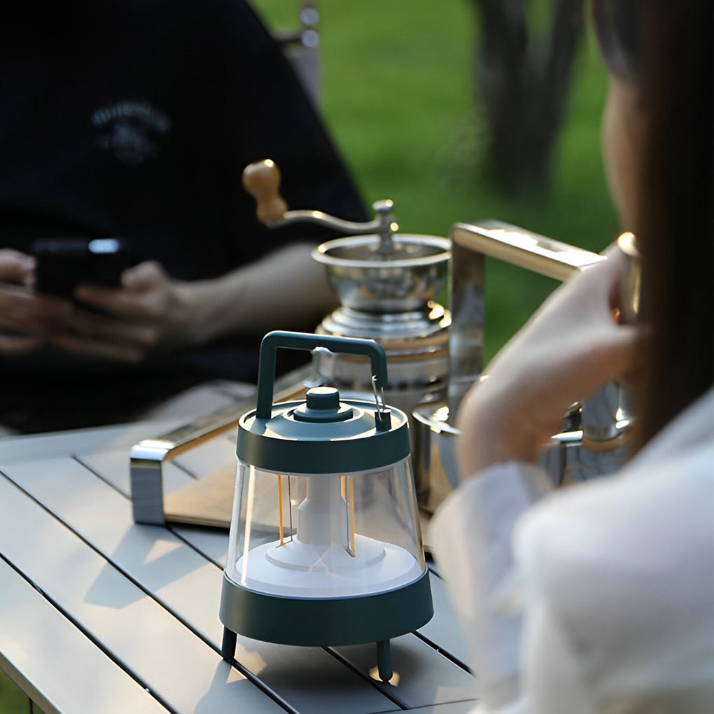 Portable rechargeable LED lamp with a close-up of its power button and light.