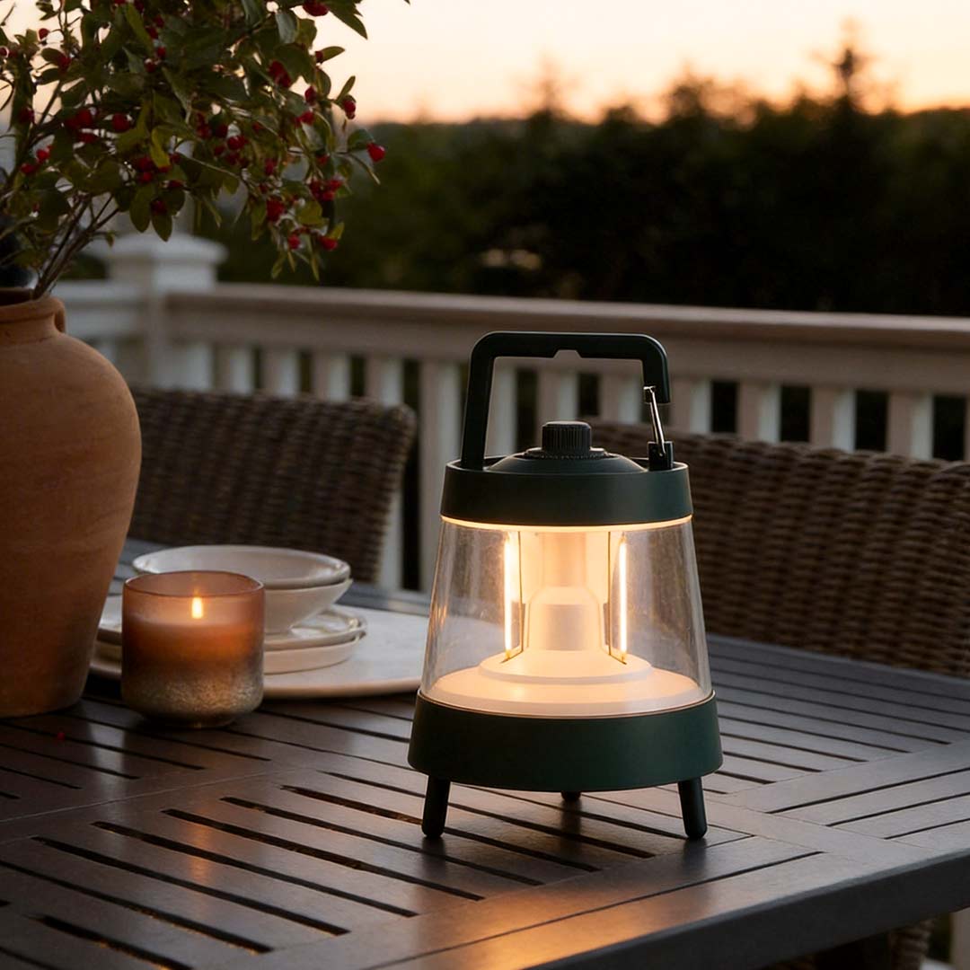 Portable rechargeable LED lamp providing warm illumination on an outdoor dining table.