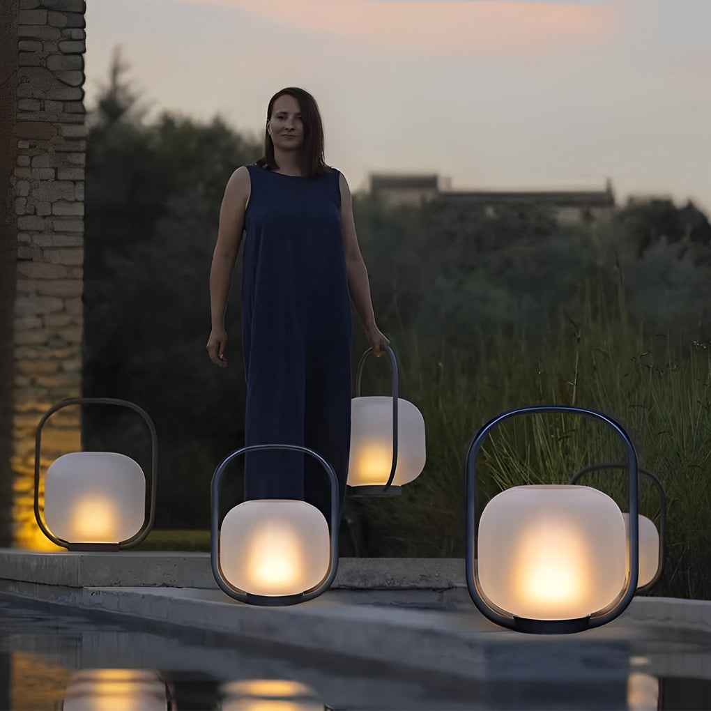 Portable solar lantern illuminating a garden pathway, providing functional and decorative light.