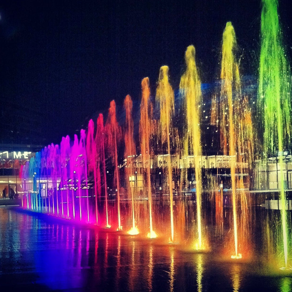 Multi-colored LED fountain lights producing vibrant rainbow water display with synchronized effects