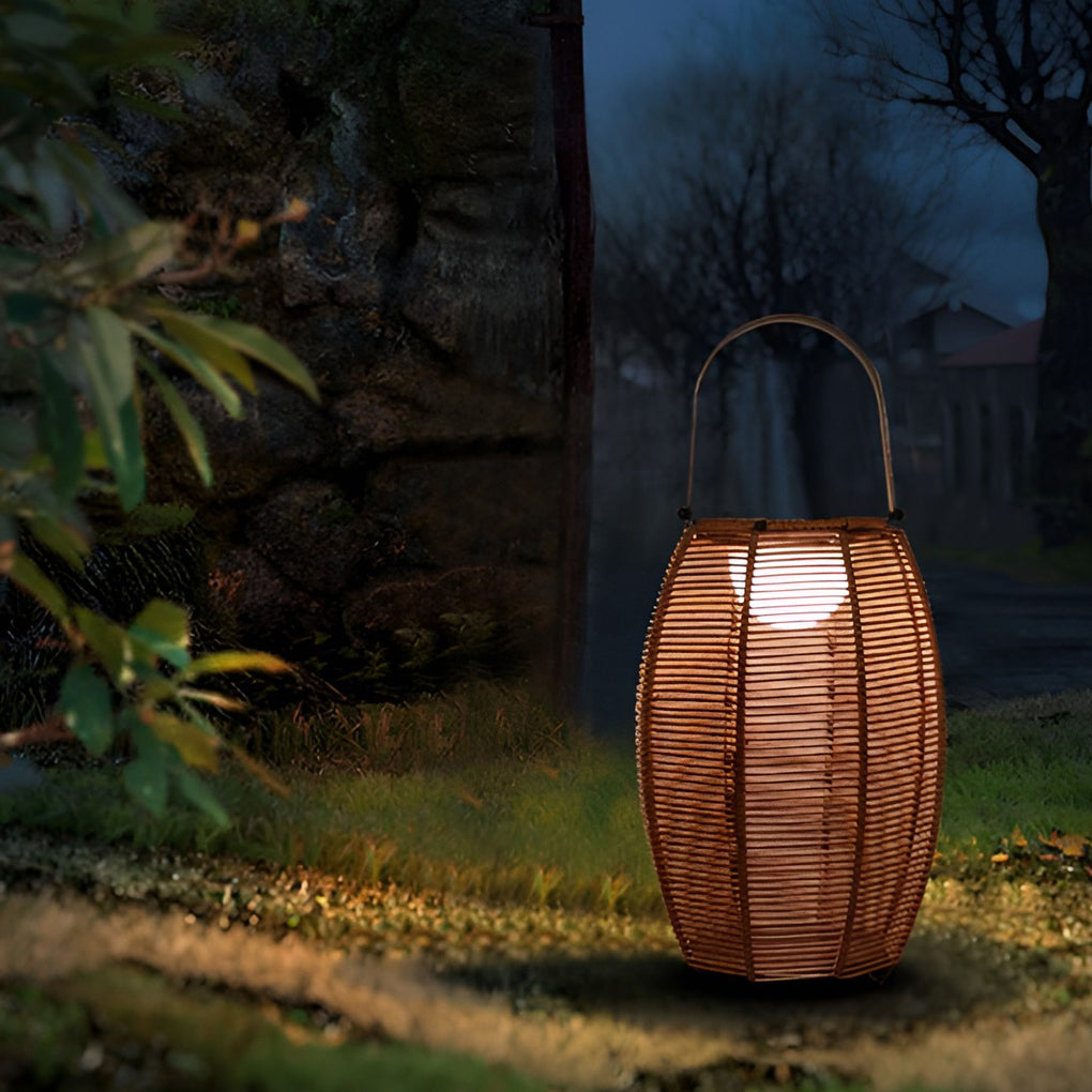 Rattan floor lantern enhancing a contemporary outdoor entrance with warm light.