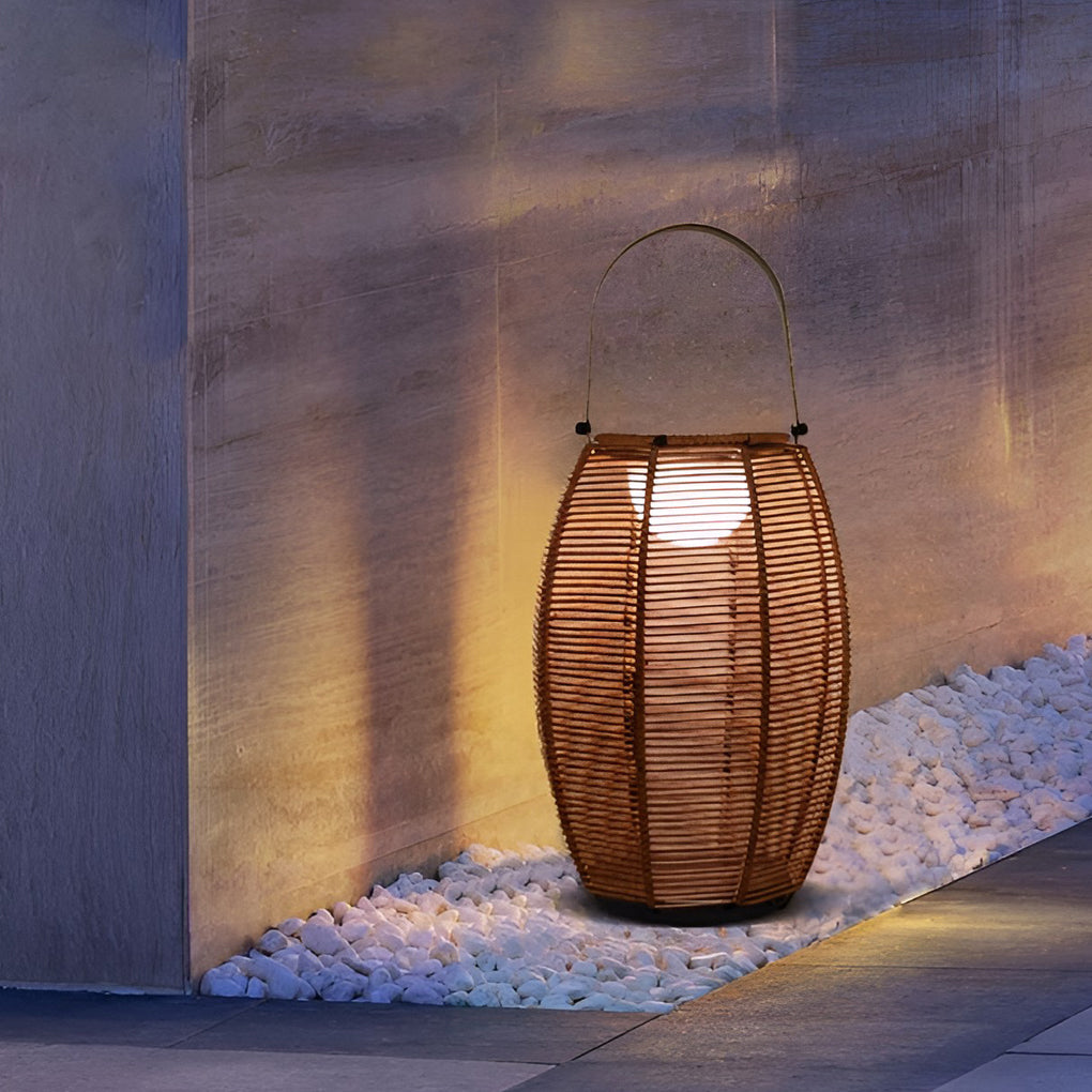 Rattan floor lantern illuminating a minimalist outdoor deck with focused glow.