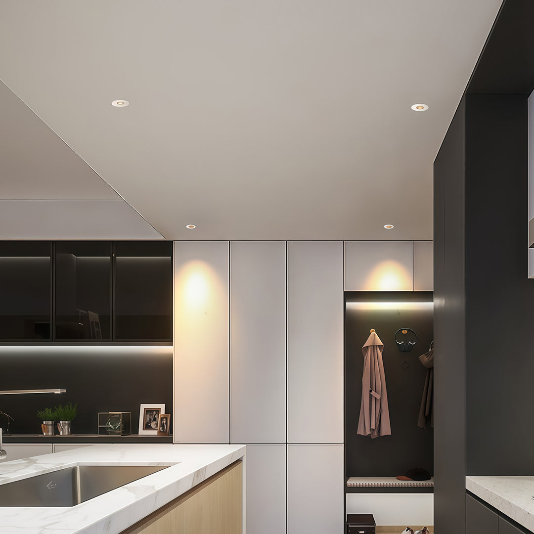 Recessed LED ceiling lights installed in contemporary kitchen providing focused task and ambient lighting.