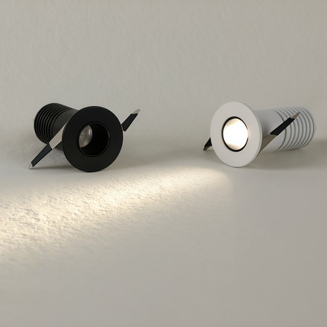 Black and white recessed ceiling spotlight fixtures displayed with chrome and powder-coated finishes.