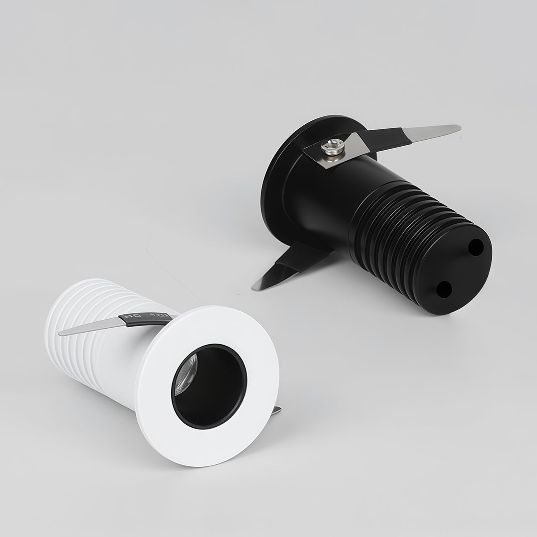 Comparison view of black and white recessed ceiling spotlights showing different finish options.