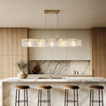 Rectangular glass chandelier with a sleek gold frame, providing elegant illumination above a modern kitchen island.