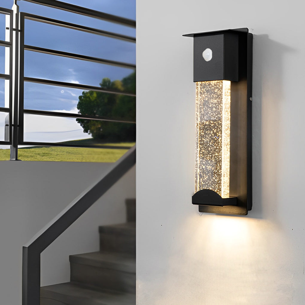 Contemporary rectangular outdoor wall lights installed along stairway exterior wall for safety lighting.