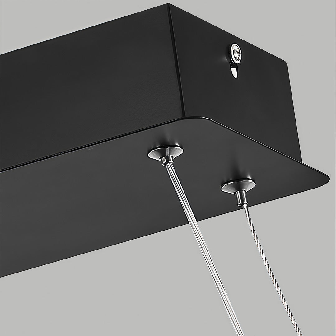 Close-up of rectangular pendant light ceiling canopy and suspension cables.