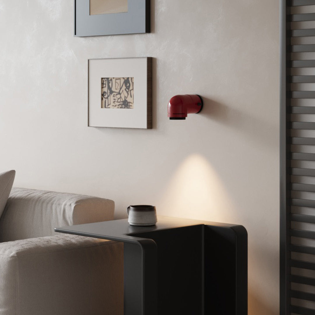 Contemporary bedroom with a red wall modern lights casting warm focused illumination.