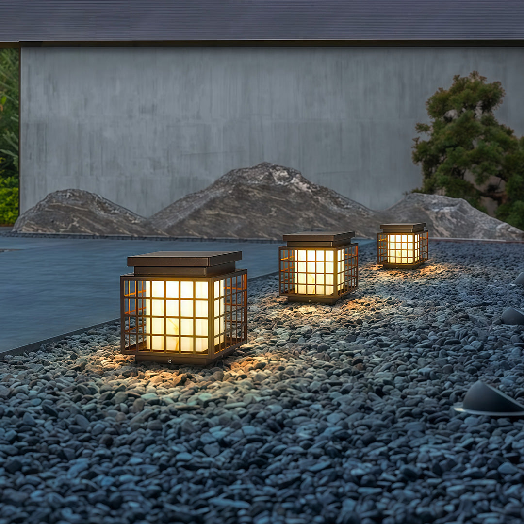 Modern gate pillar lights with a black square design, enhancing the entrance of a residential driveway.