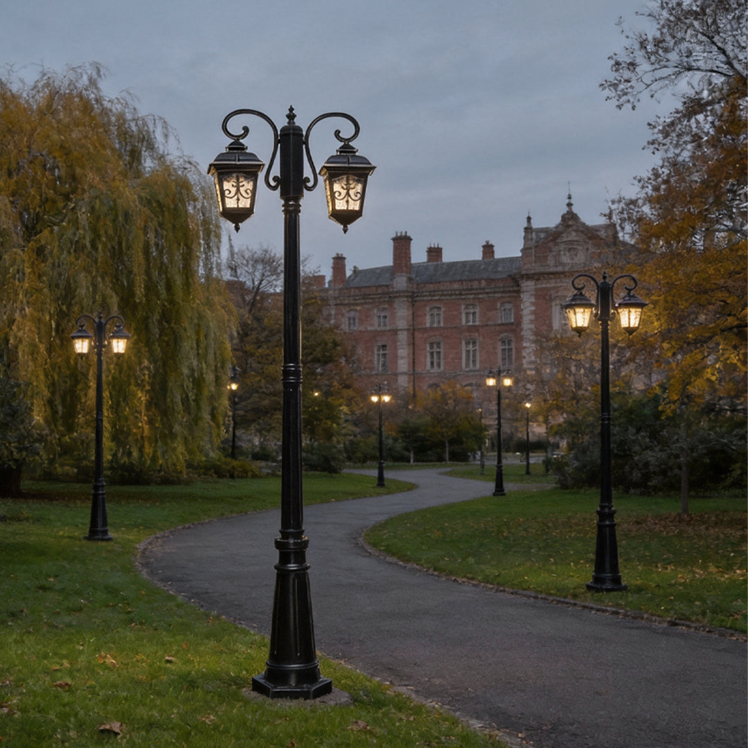 Retro outdoor lamp post installed along a park pathway at dusk