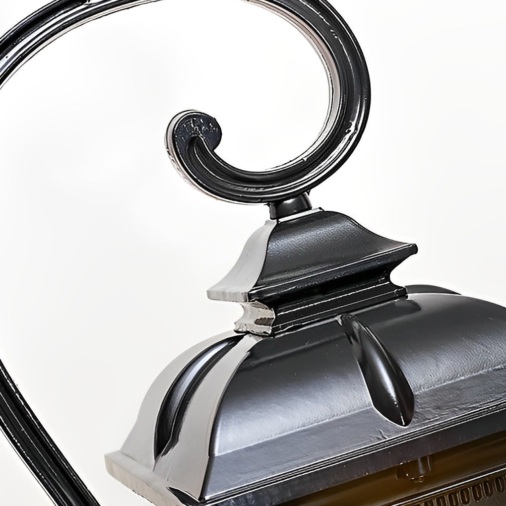 Retro outdoor lamp post top detail with curved metal arm design