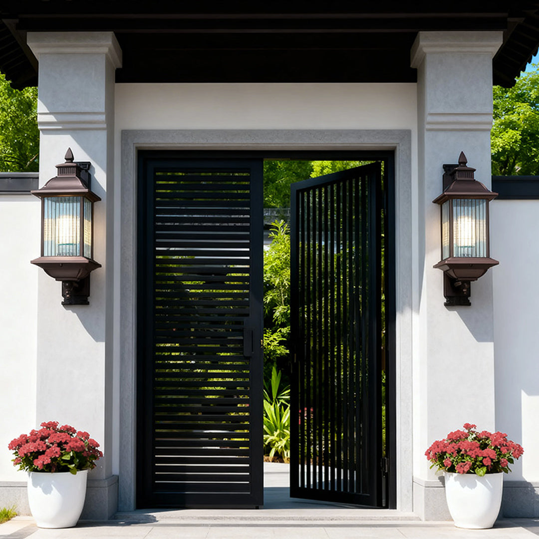 Pair of retro outdoor wall lights flanking modern black front door on white home exterior