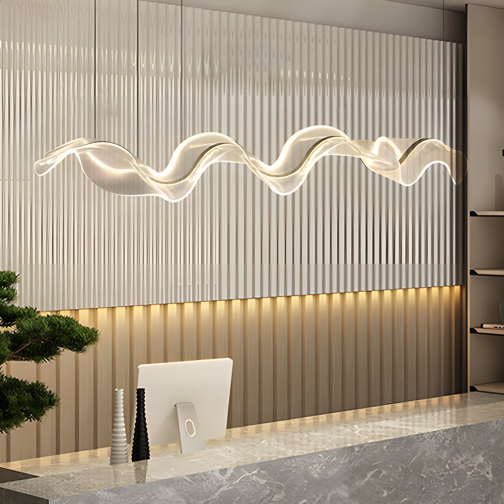 Ribbon pendant light with a wave design, hanging above a minimalist dining table.