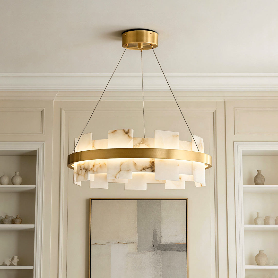 Elegant ring-shaped copper modern chandelier featuring faux alabaster stone panels illuminating an upscale room.