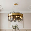 Sophisticated ring-shaped modern traditional chandeliers featuring a wide gold band and sleek smoky glass panels in an elegant room.