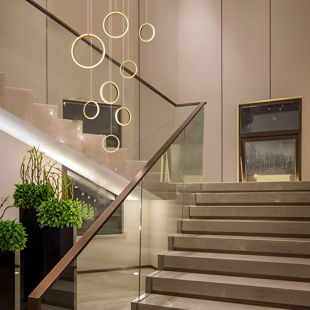 Ring staircase pendant light adding a luxurious touch to a staircase with marble steps.