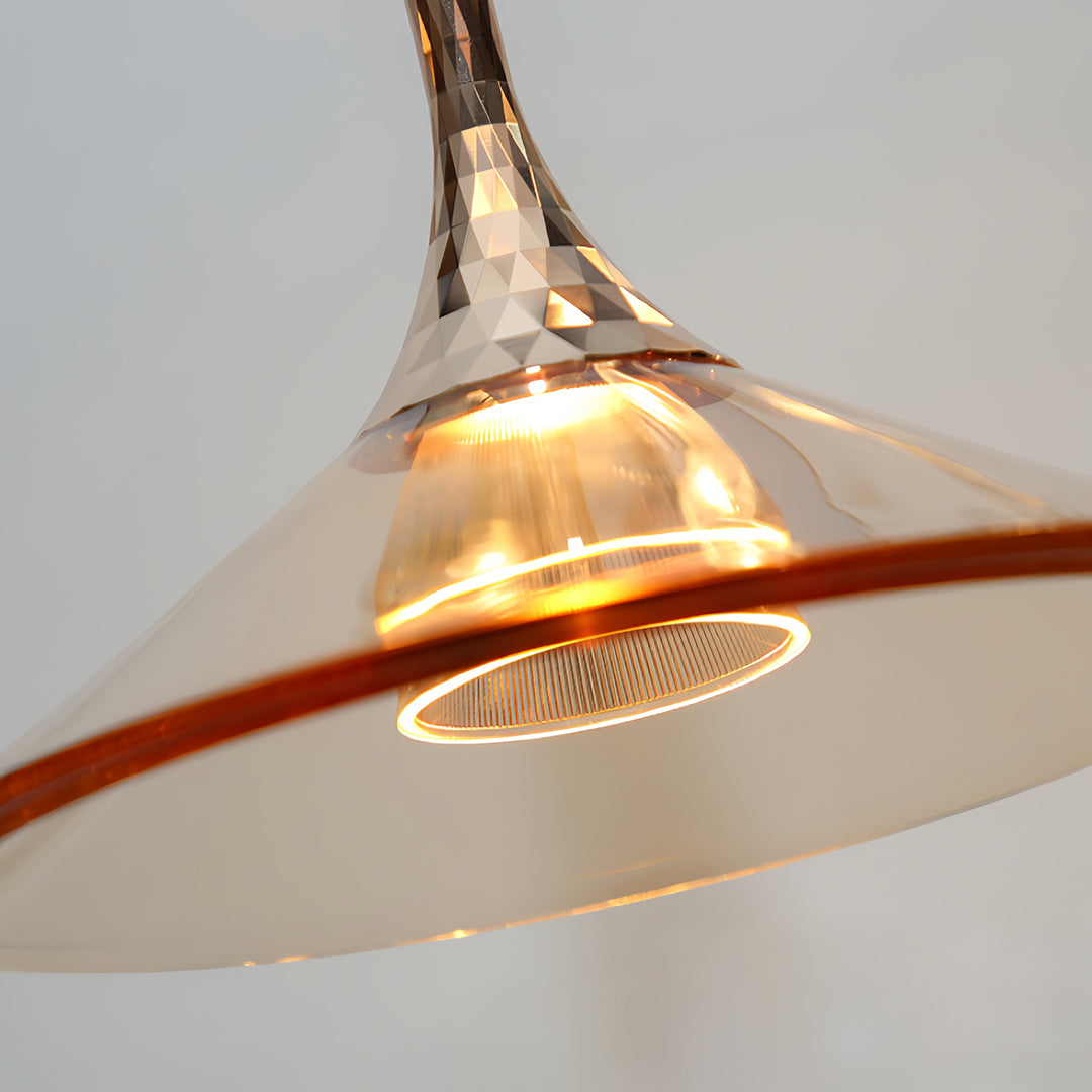 Close-up detail of rise and fall pendant lights showing copper shade with decorative ribbed edge