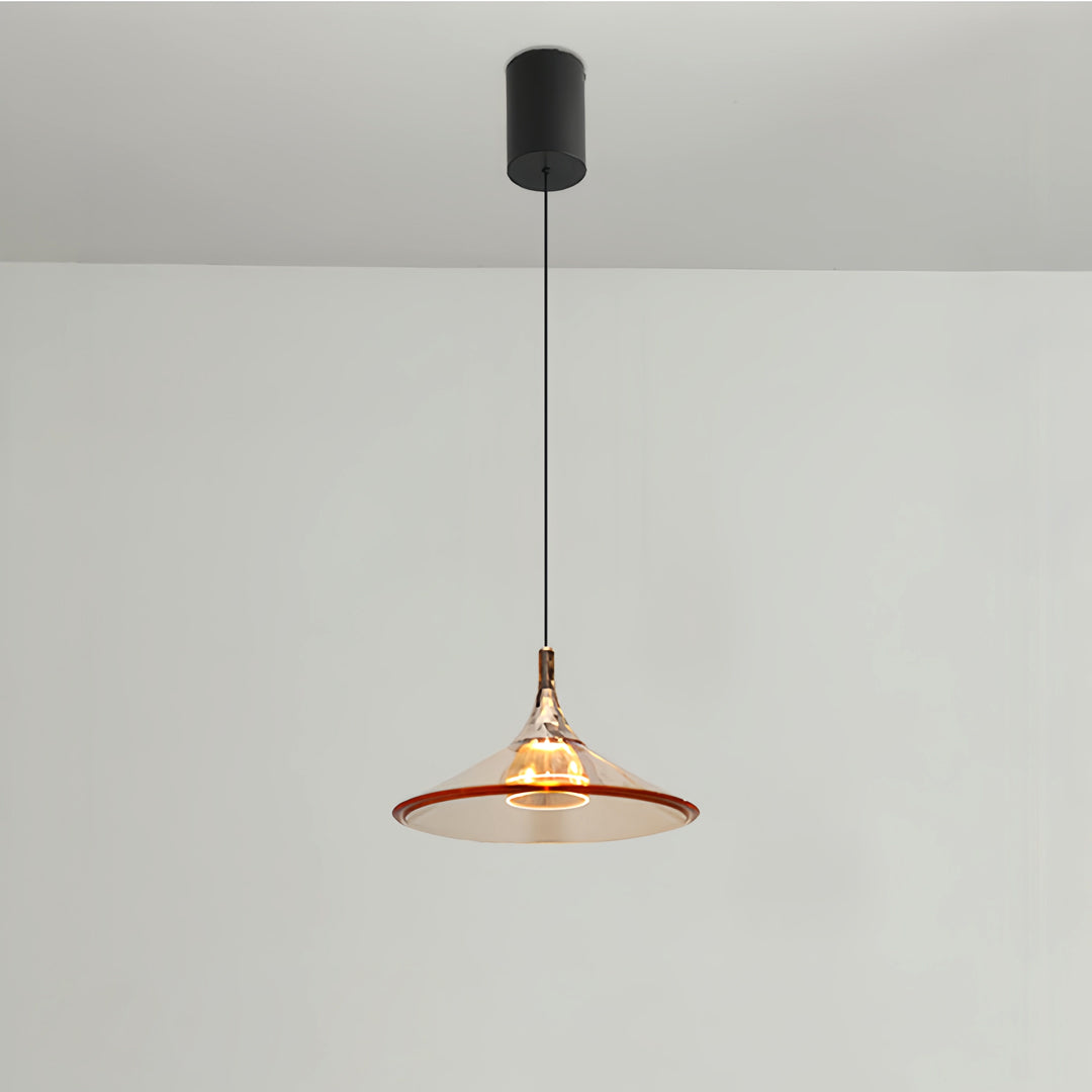 Rise and fall pendant lights with warm metallic finish providing focused task lighting on white surface