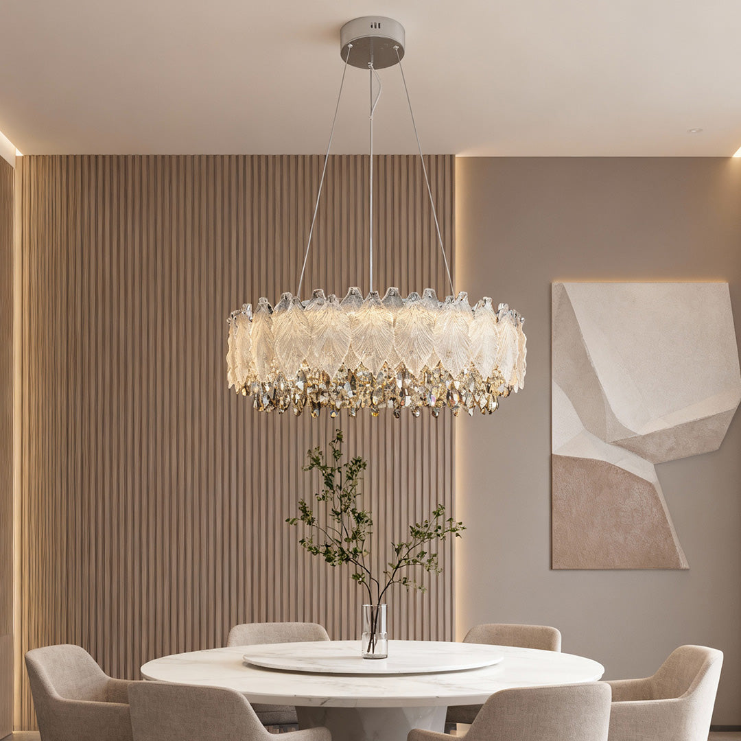 Round country French chandelier illuminating neutral dining room with wall art.