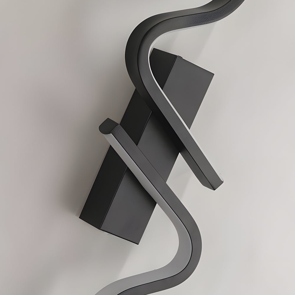 Sculptural modern curved wall sconce in a neutral tone, providing ambient lighting and a sophisticated touch to the room.
