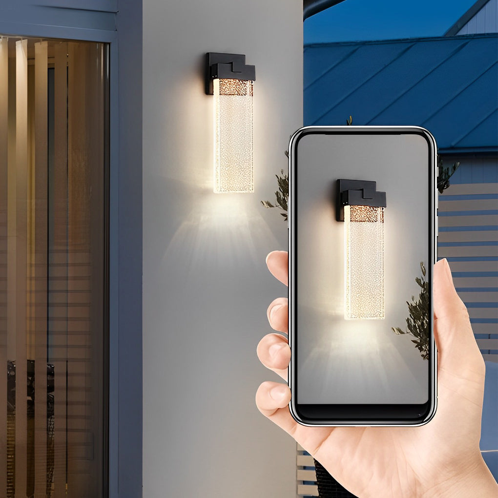 Seeded glass outdoor wall lighting near a modern entrance, providing warm illumination.