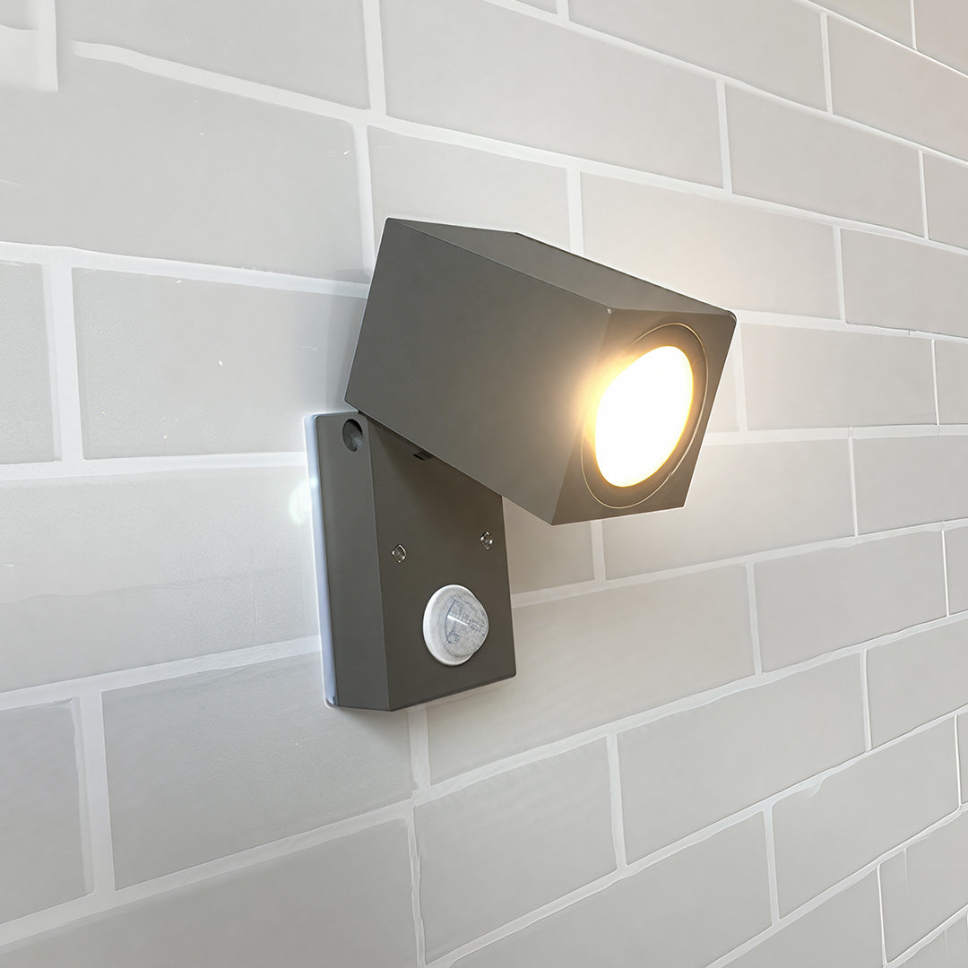 Black sensor wall lights outdoor with motion detection, mounted on a brick wall.