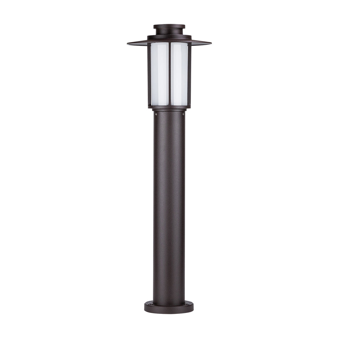 Short lantern-style bollard light in landscaped garden with rocks and plants