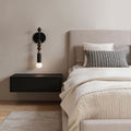 Modern silver wall lights beside a minimalist bedroom with exposed bulb design and warm ambient illumination.