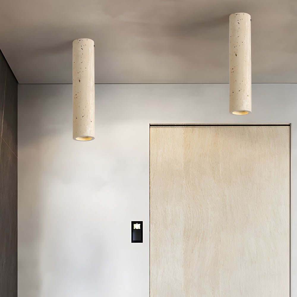Single cylinder downlight mounted on a white ceiling, offering focused and elegant lighting in a modern interior.
