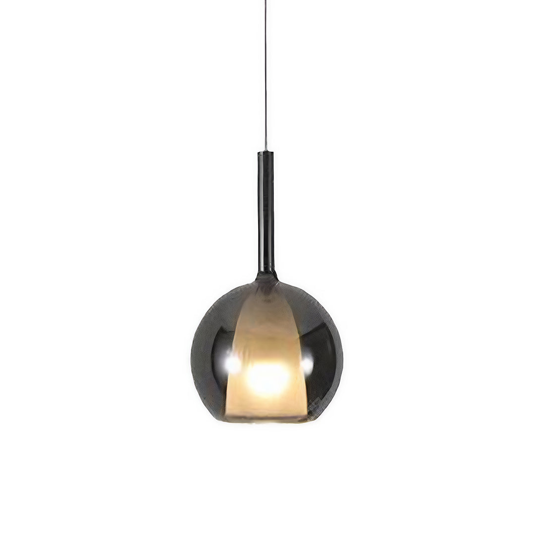 Single glass ball pendant light with a warm glow, perfect for cozy and intimate dining spaces.