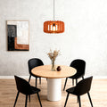 Single orange wooden slat Nordic pendant lights fixture over a minimalist dining table.