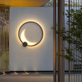 Single decorative outdoor wall light mounted on white exterior wall with warm ambient glow