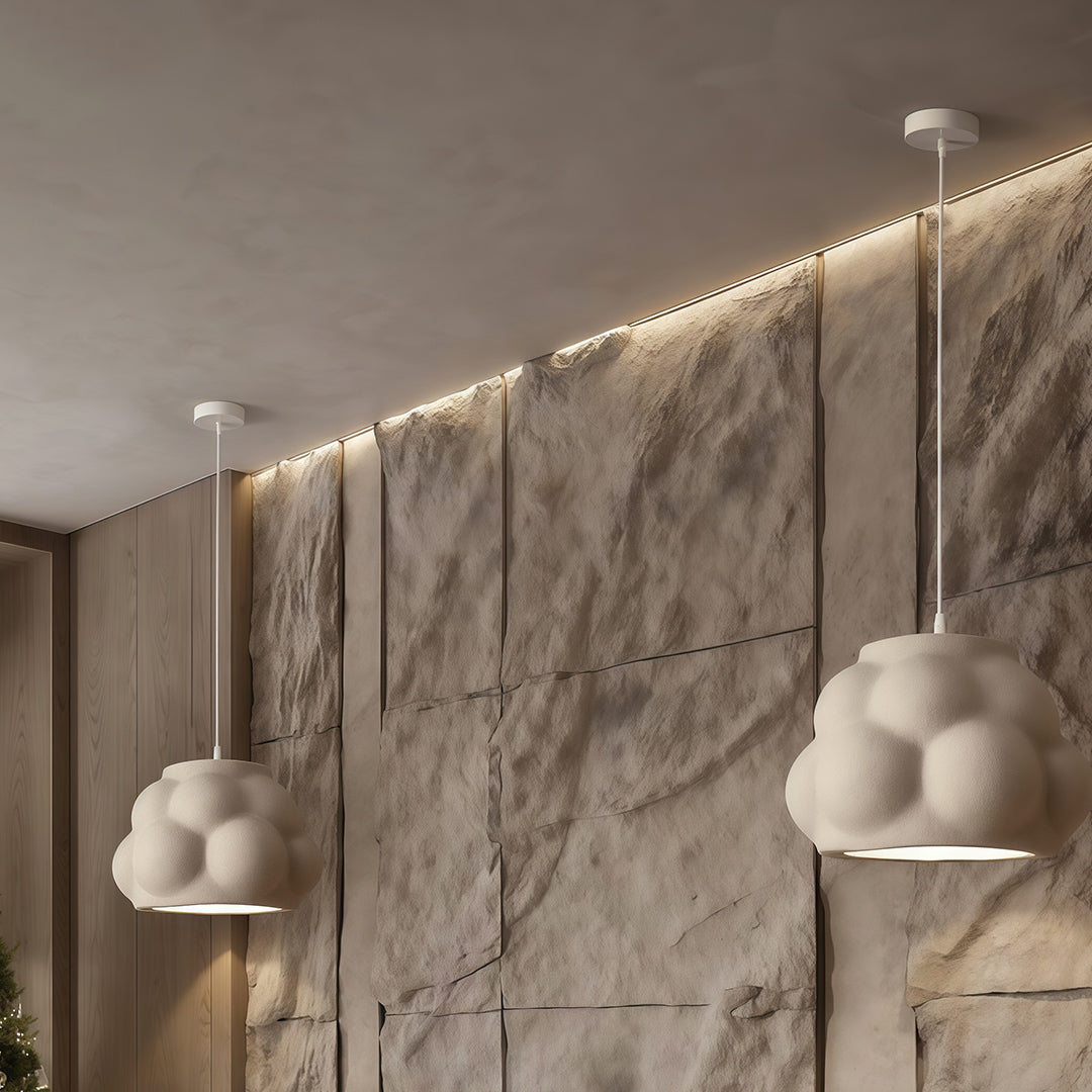 Single pendant light fixture mounted on marble wall, adding soft glow to modern hallway.