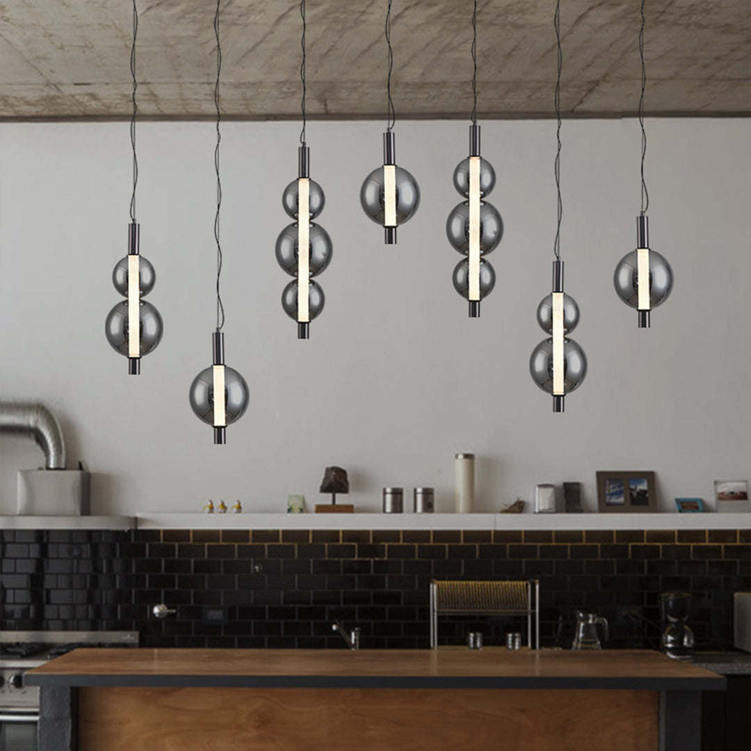 Single modern silver pendant light with transparent globe suspended from black ceiling mount in living room