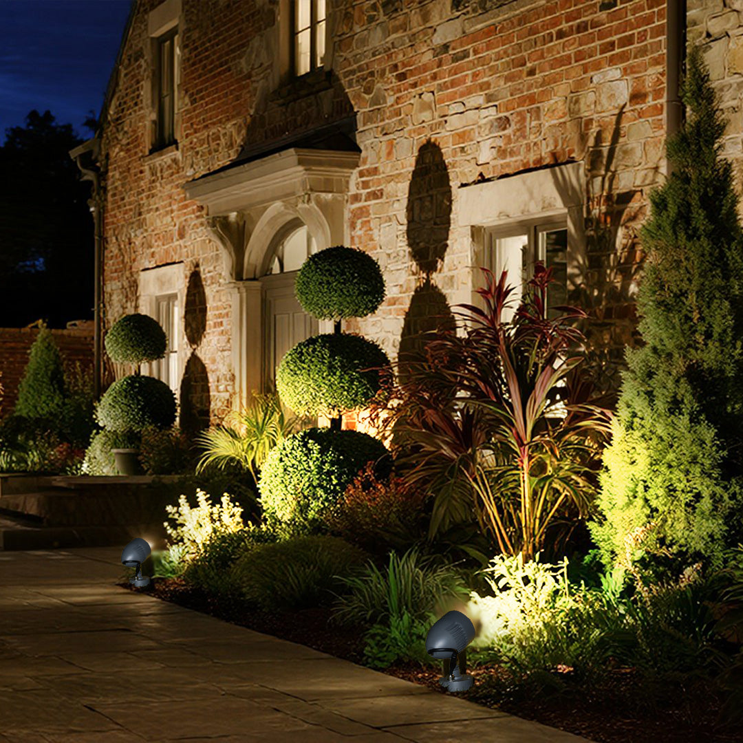 Sleek black outdoor spotlight with adjustable head mounted on sturdy cylindrical base stand