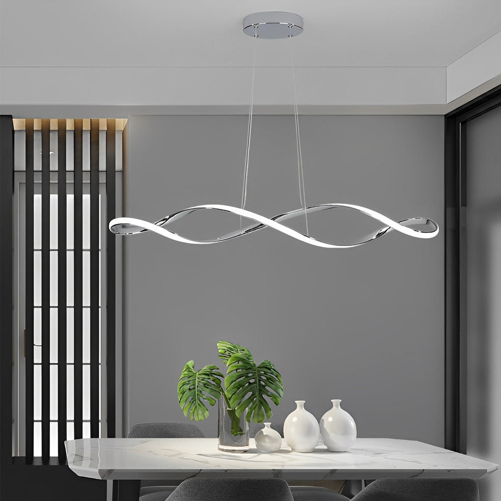 Waveform pendant light with sleek black design hanging above modern dining table and chairs.