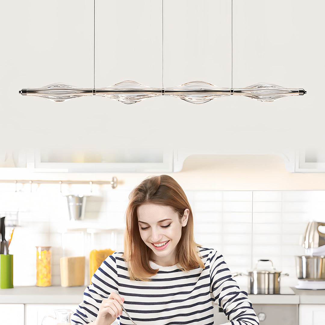Sleek crystal pendant lights for kitchen island suspended above a kitchen counter, adding sophistication to the space.