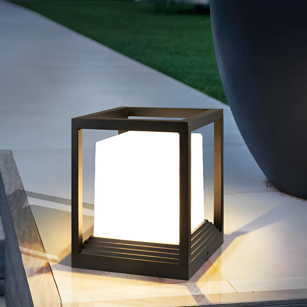 Garden pedestal lights with sleek black design on outdoor patio near water feature.