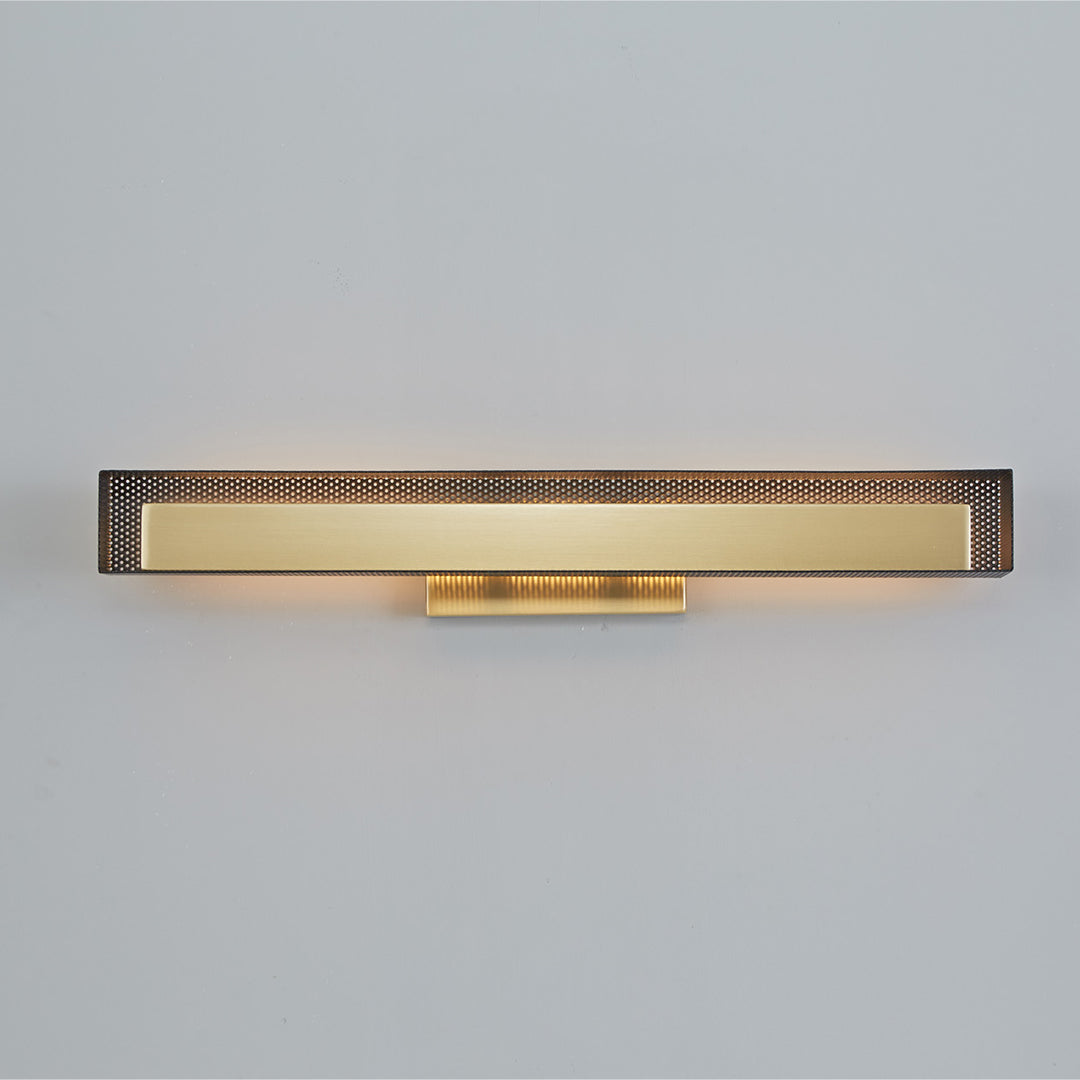 Sleek gold wall picture lights with perforated detail, viewed from above.