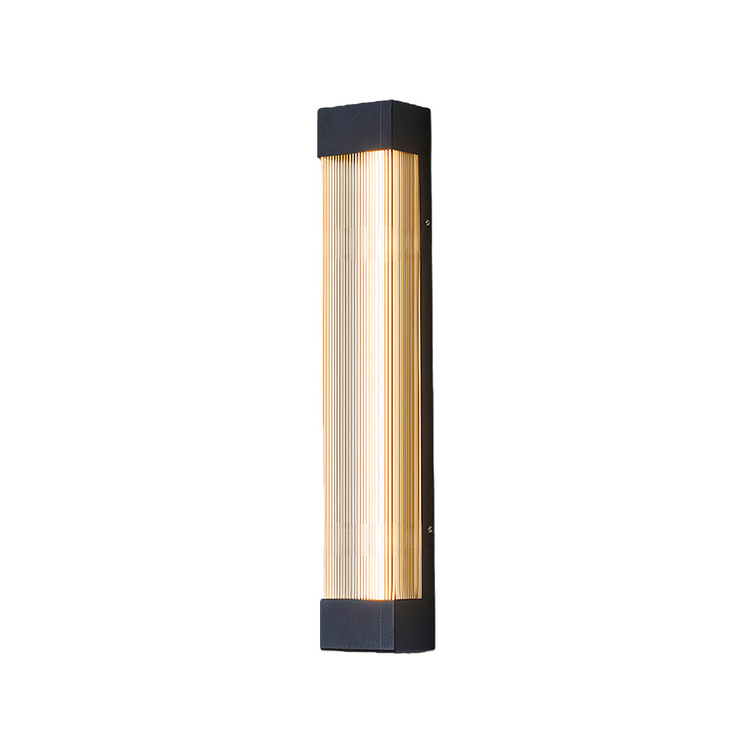 Sleek linear outdoor sconce shown illuminated with a warm amber-colored light, isolated on white.