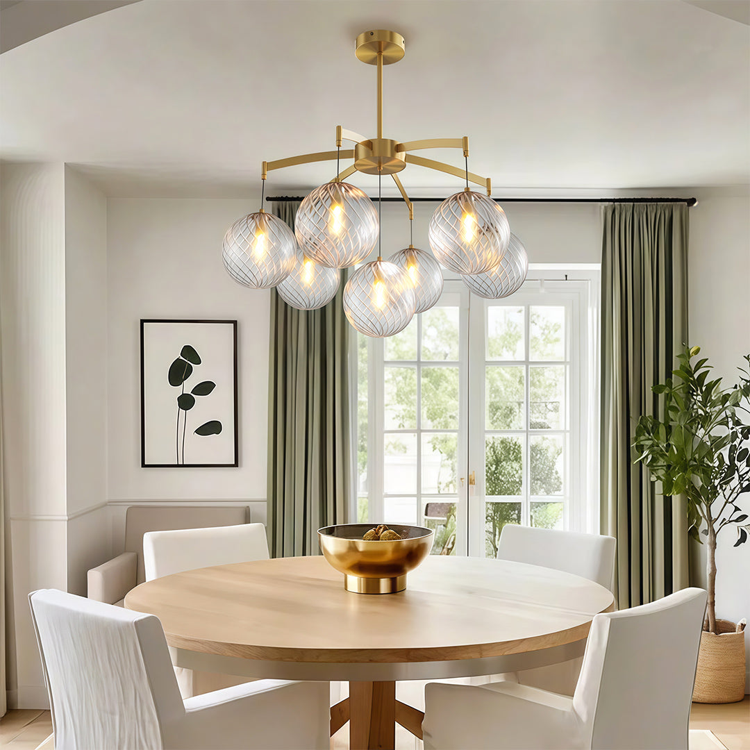 Sleek modern glass ball chandelier with a multi-arm design, adding sophistication to a dining area.