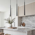 Trio of sleek Slim Black Pendant Light fixtures hanging over a luxury marble kitchen island.