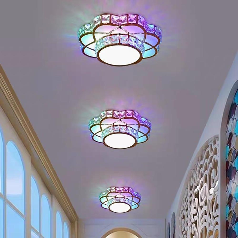 Small crystal flush mount ceiling light creating colorful light reflections on the ceiling.