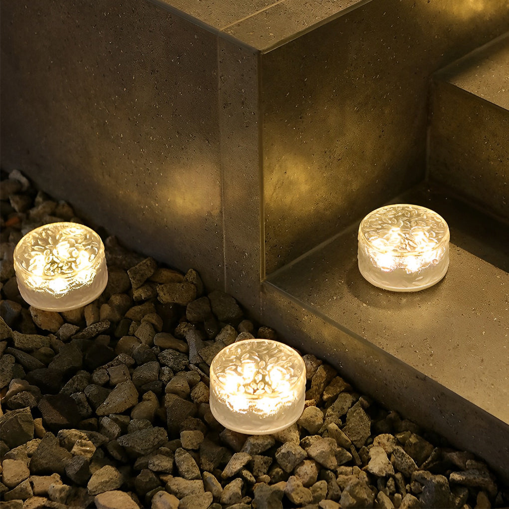 Small step lights installed near concrete steps highlighting corner and elevation changes.