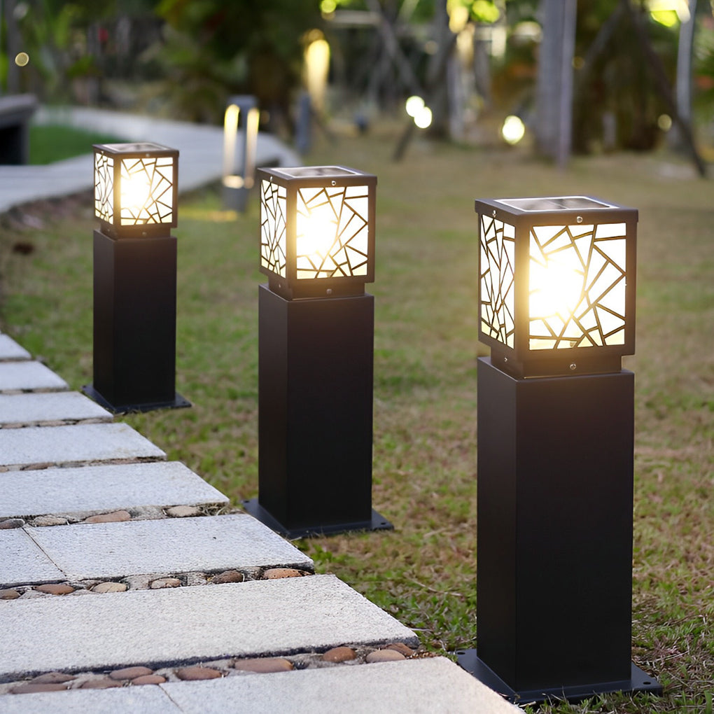 Solar bollard path lights providing soft illumination along a curved brick pathway.