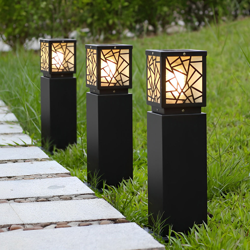 Solar bollard path lights enhancing a modern outdoor seating area with warm light.